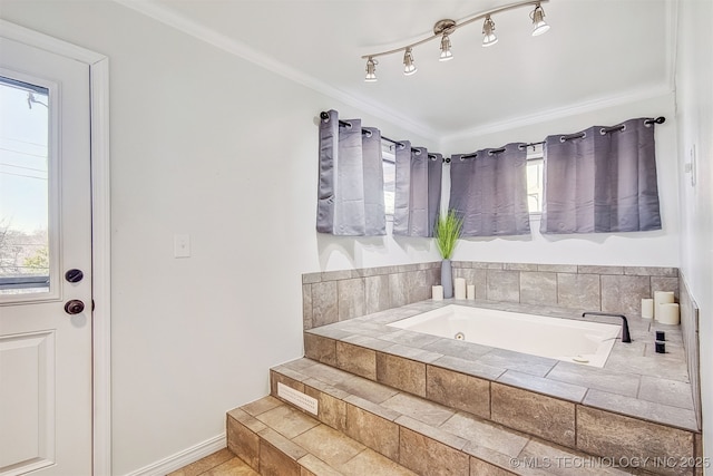 bathroom with a relaxing tiled tub and crown molding