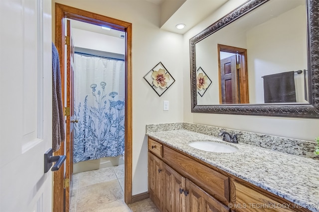 bathroom featuring vanity and curtained shower