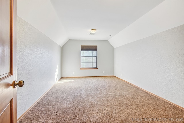 additional living space with lofted ceiling and carpet floors