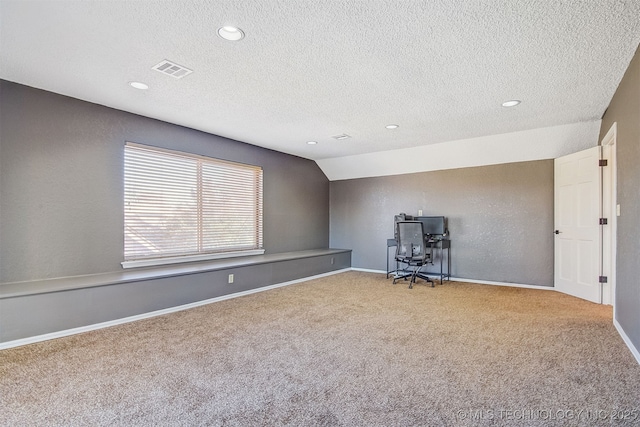 interior space with lofted ceiling and a textured ceiling