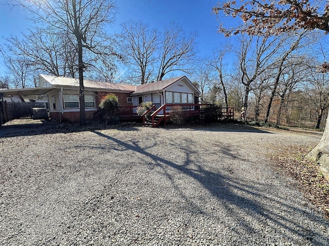 view of front of home featuring a carport and a deck