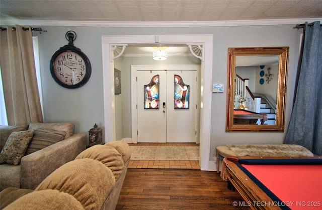 foyer featuring french doors, dark hardwood / wood-style flooring, and crown molding