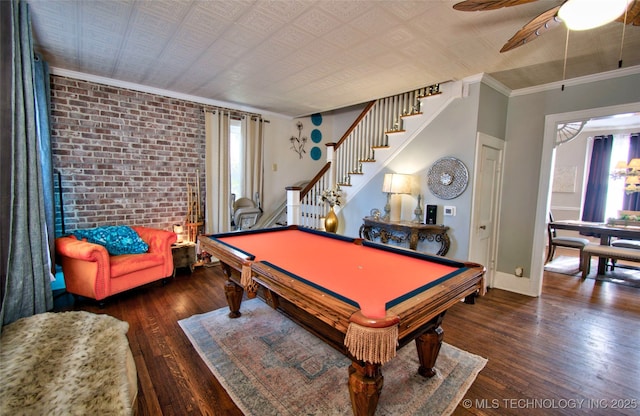 playroom with brick wall, pool table, ceiling fan, crown molding, and dark wood-type flooring