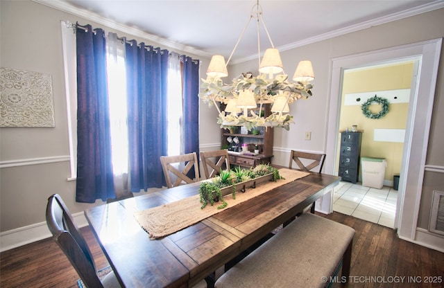 dining area with dark wood-type flooring and ornamental molding