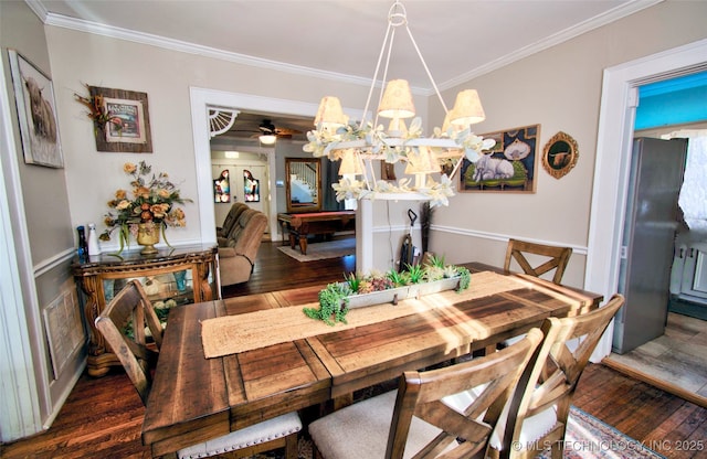 dining space with ornamental molding and dark hardwood / wood-style floors