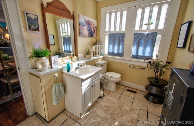 bathroom with vanity, tile patterned flooring, and toilet