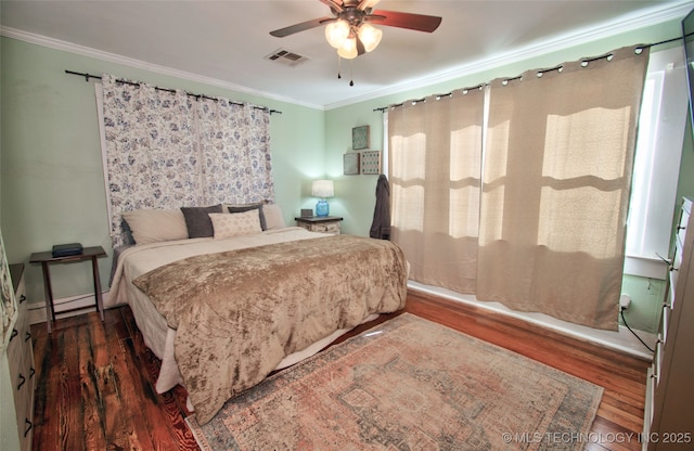 bedroom with crown molding, ceiling fan, and dark hardwood / wood-style flooring