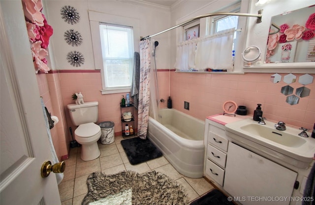 full bathroom with shower / bathtub combination with curtain, tile walls, vanity, tile patterned floors, and toilet