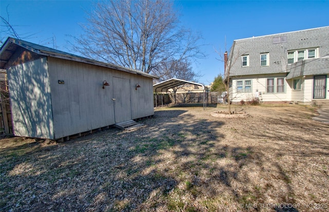 view of yard with a carport and a shed