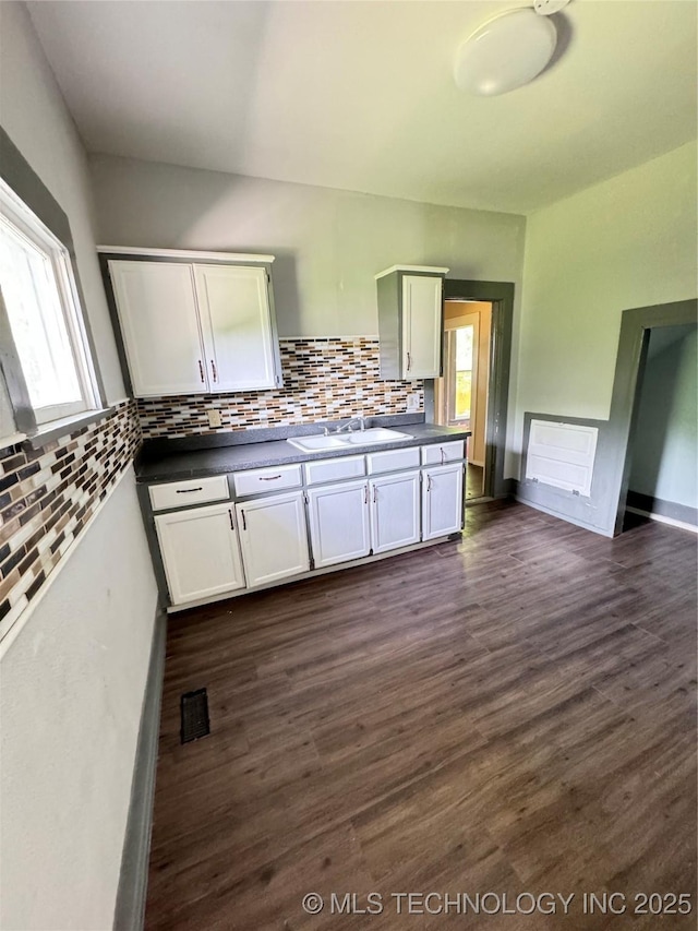 kitchen featuring plenty of natural light, sink, white cabinets, and dark hardwood / wood-style floors