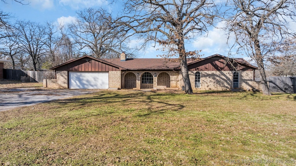 ranch-style home featuring a garage and a front yard