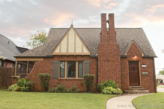 tudor house featuring a front yard