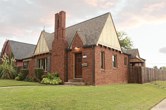 english style home with a front lawn