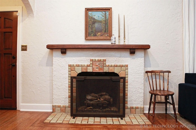 details with hardwood / wood-style floors and a fireplace