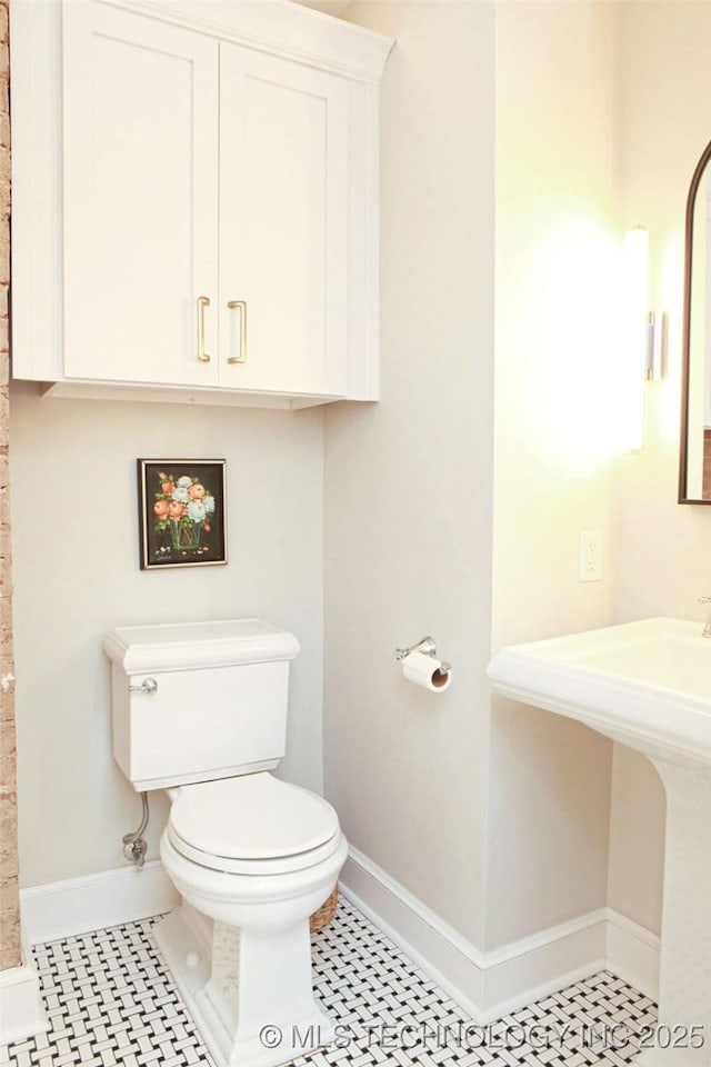 bathroom with tile patterned flooring and toilet