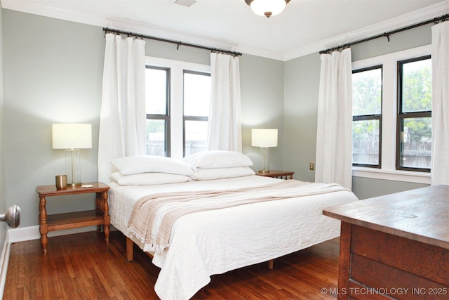 bedroom featuring dark hardwood / wood-style flooring and crown molding