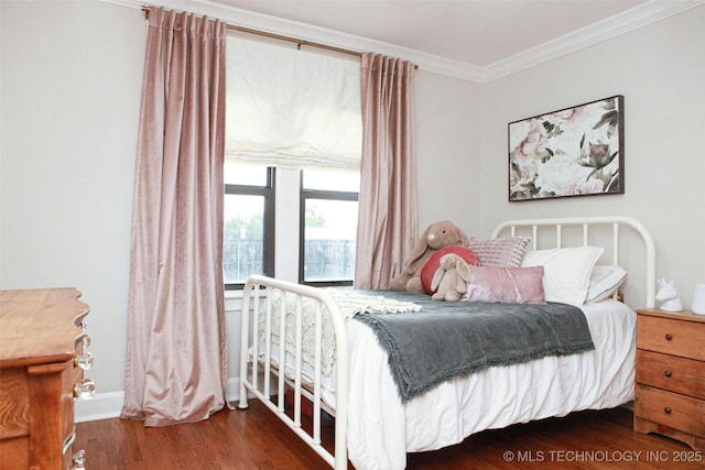 bedroom with crown molding and dark hardwood / wood-style floors