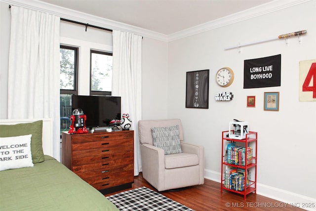 bedroom with ornamental molding and hardwood / wood-style floors