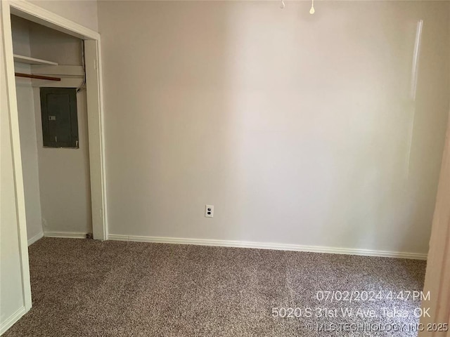 carpeted empty room featuring electric panel