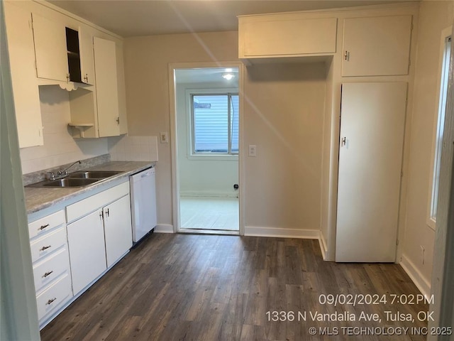 kitchen with sink, white cabinetry, dark hardwood / wood-style floors, white dishwasher, and decorative backsplash