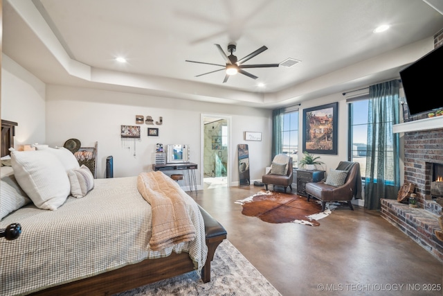 bedroom with concrete flooring, a brick fireplace, and ceiling fan