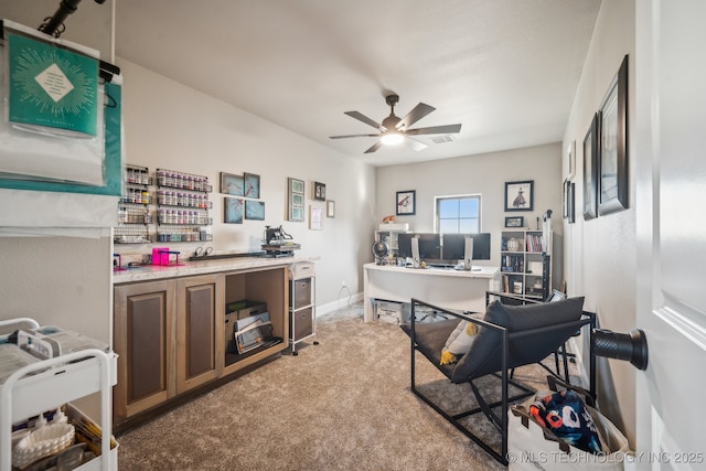 carpeted office space with ceiling fan