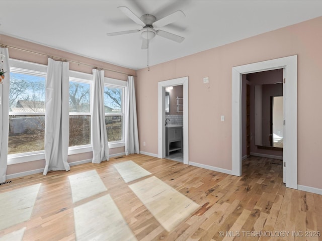 unfurnished room featuring ceiling fan and light hardwood / wood-style flooring