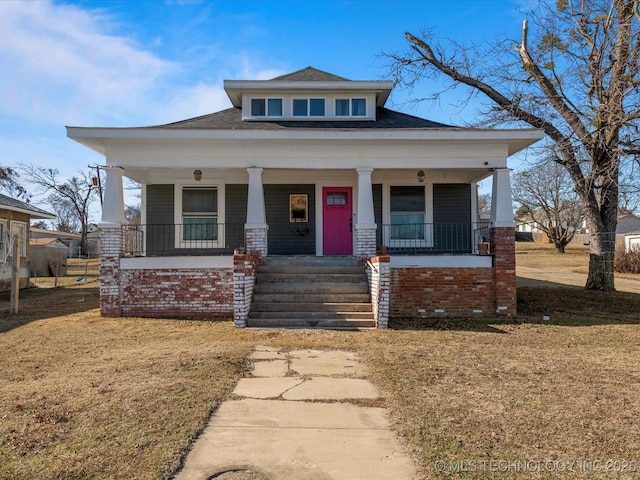 bungalow-style house with covered porch and a front lawn