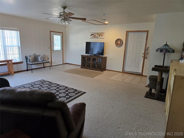 carpeted living room with ceiling fan