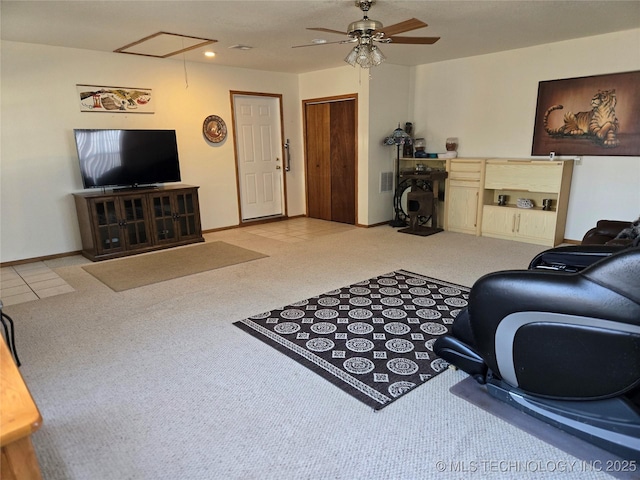 carpeted living room with ceiling fan