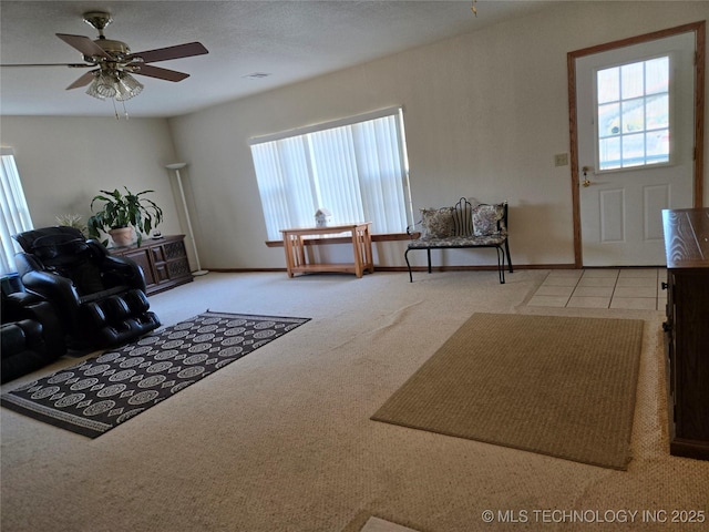 carpeted living room with plenty of natural light and ceiling fan