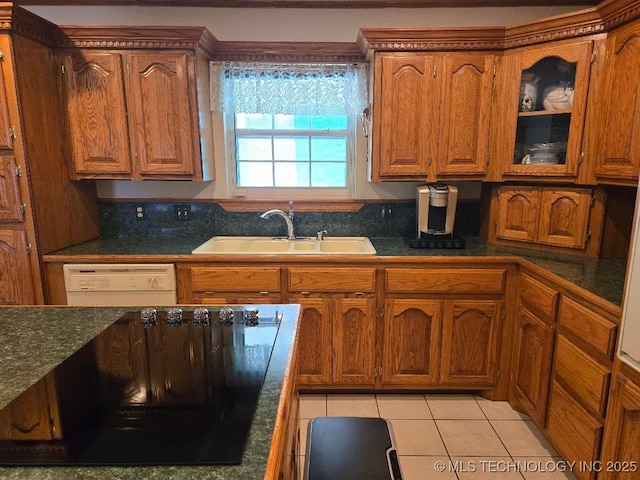 kitchen featuring dishwasher, sink, and light tile patterned floors