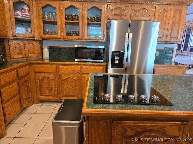 kitchen featuring light tile patterned flooring and appliances with stainless steel finishes