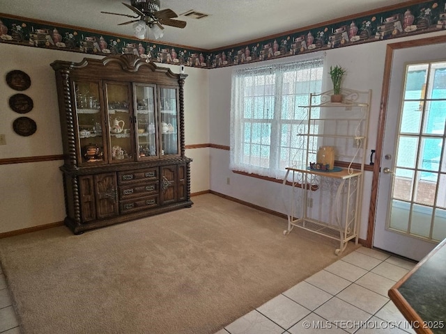 tiled dining room featuring a wealth of natural light and ceiling fan