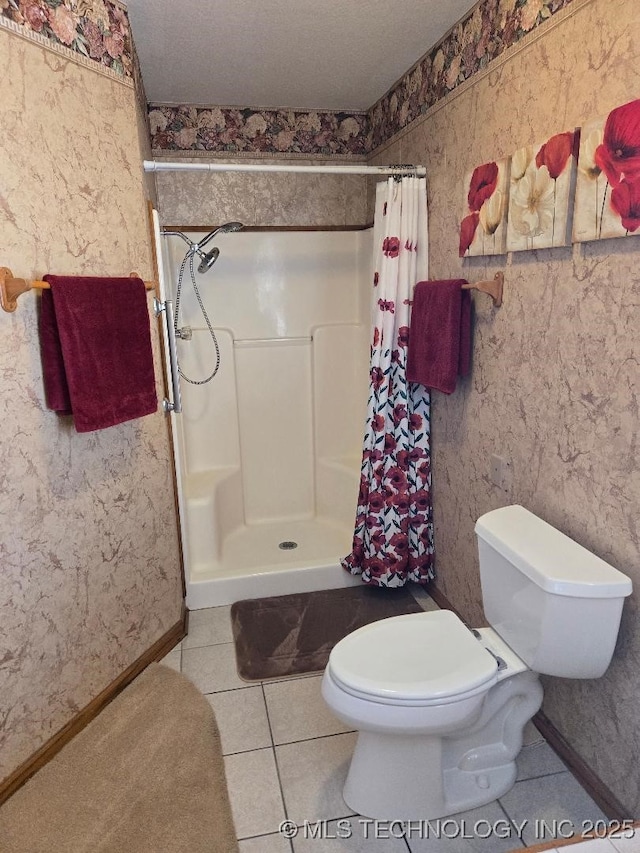 bathroom with tile patterned floors, toilet, and a shower with shower curtain