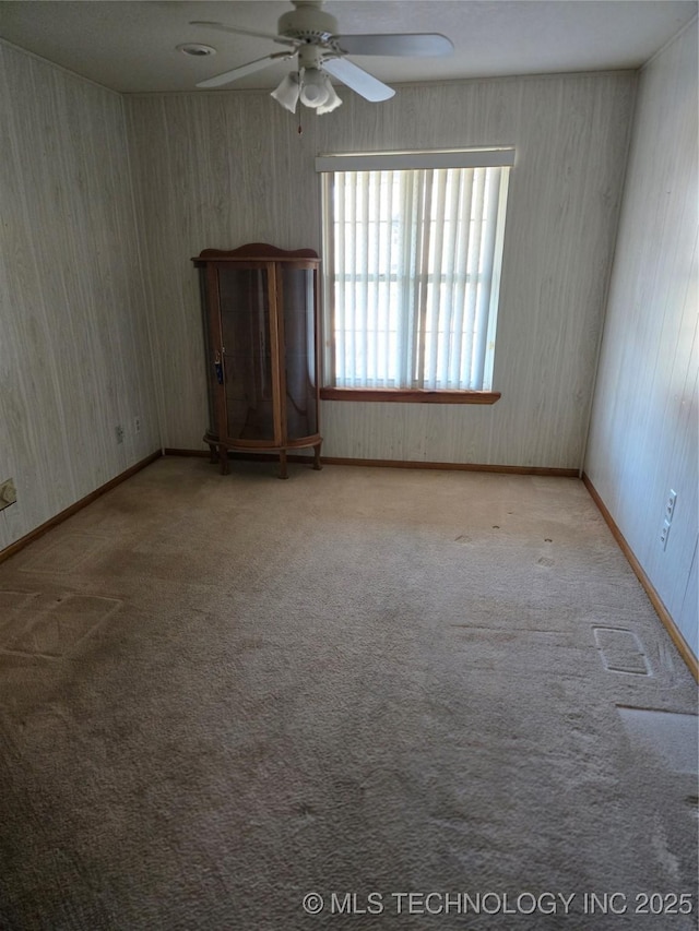 empty room with ceiling fan and light colored carpet