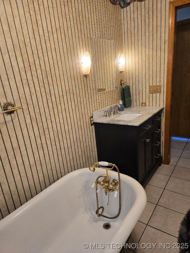 bathroom featuring vanity, a bath, and tile patterned floors