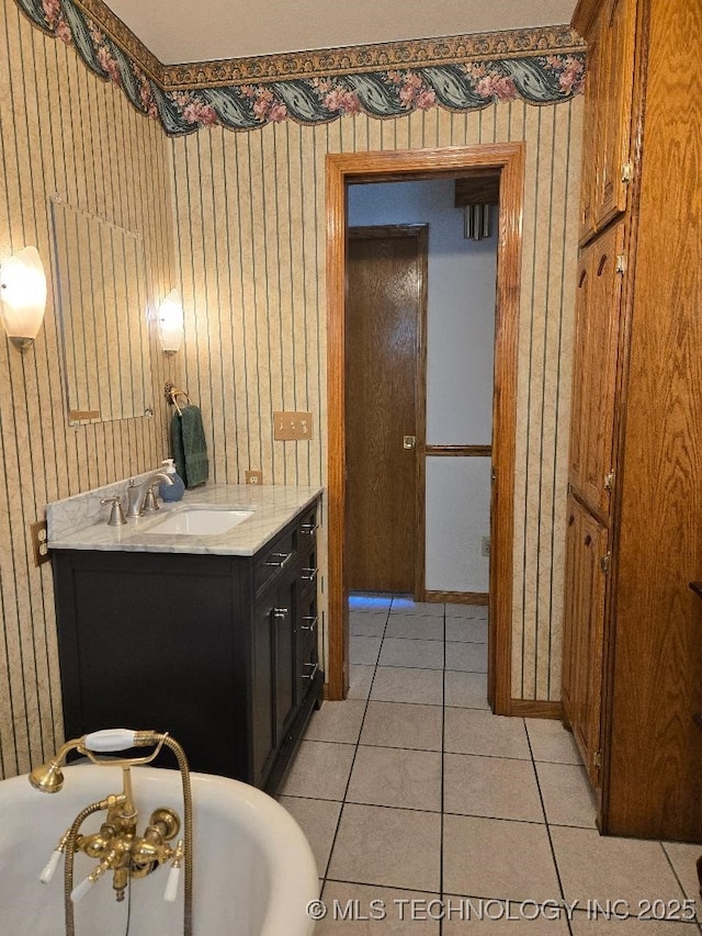 bathroom featuring tile patterned flooring, vanity, and a bathing tub