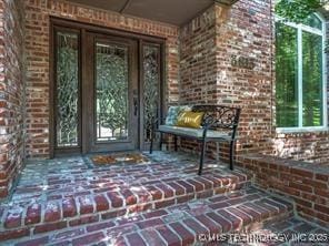 view of exterior entry with covered porch