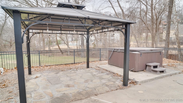 view of patio with a hot tub and a gazebo