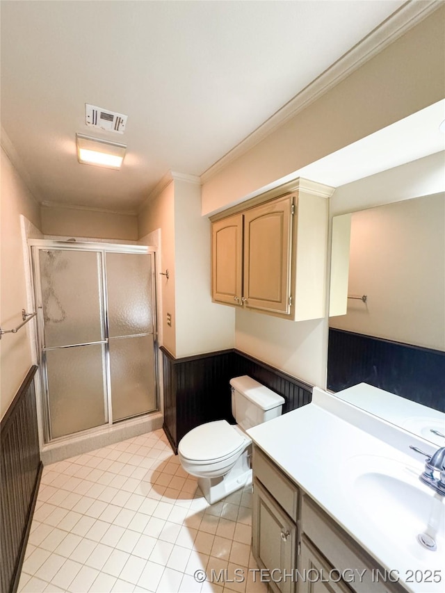 bathroom with tile patterned floors, toilet, an enclosed shower, crown molding, and wooden walls