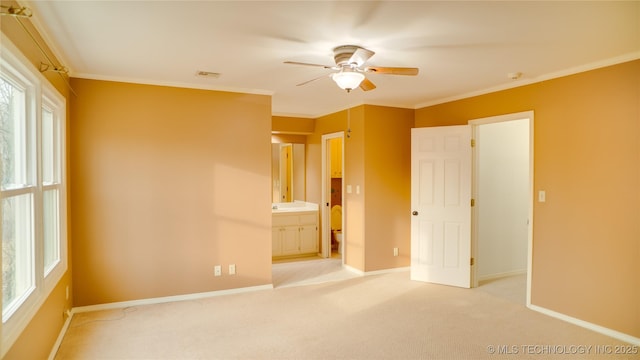 unfurnished bedroom featuring ceiling fan, ensuite bath, light colored carpet, and multiple windows