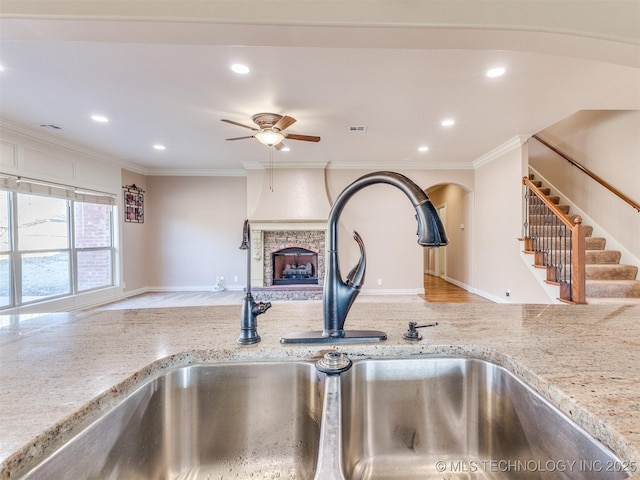 room details featuring sink, ornamental molding, and ceiling fan