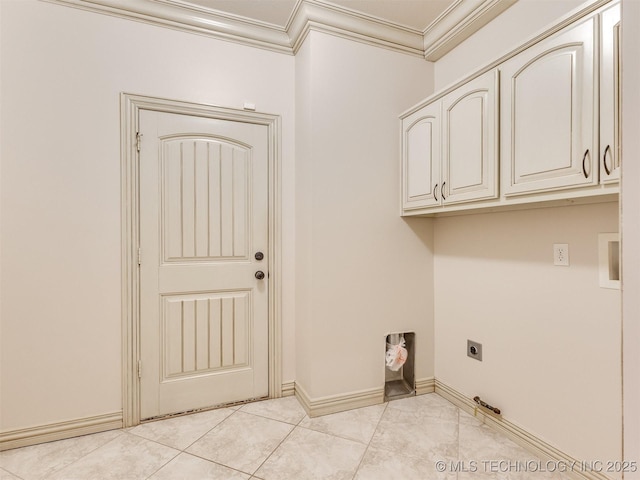 washroom with electric dryer hookup, light tile patterned floors, crown molding, and cabinets