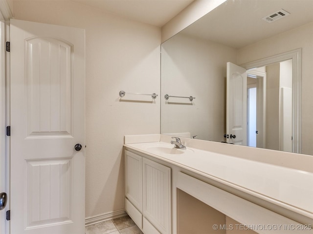 bathroom with tile patterned floors and vanity