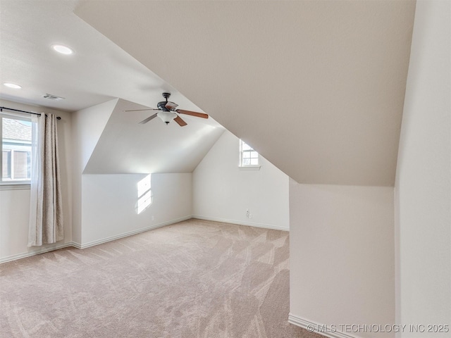 bonus room featuring plenty of natural light, light colored carpet, ceiling fan, and vaulted ceiling