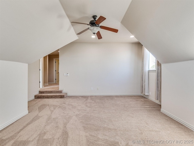 bonus room featuring baseboards, carpet floors, and vaulted ceiling