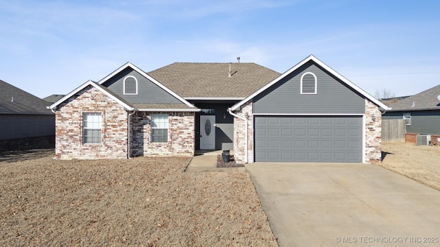 ranch-style house with cooling unit and a garage