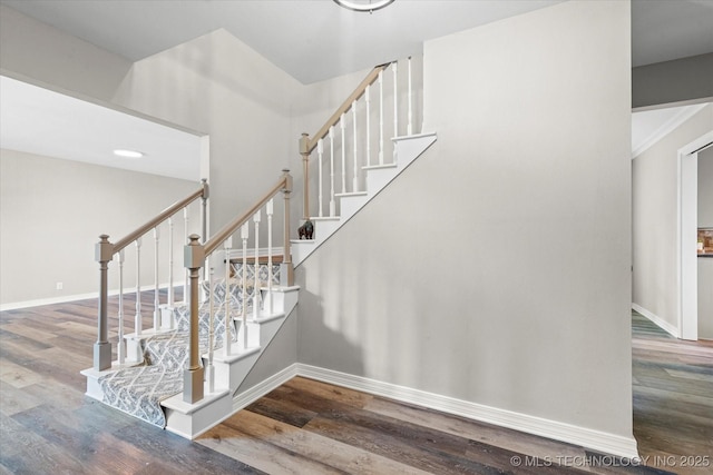 stairs with wood finished floors and baseboards