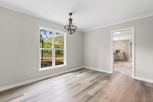 2936 Ridge Rd, Bartlesville, OK 74006 - unfurnished dining area with a chandelier, wood finished floors, baseboards, and ornamental molding